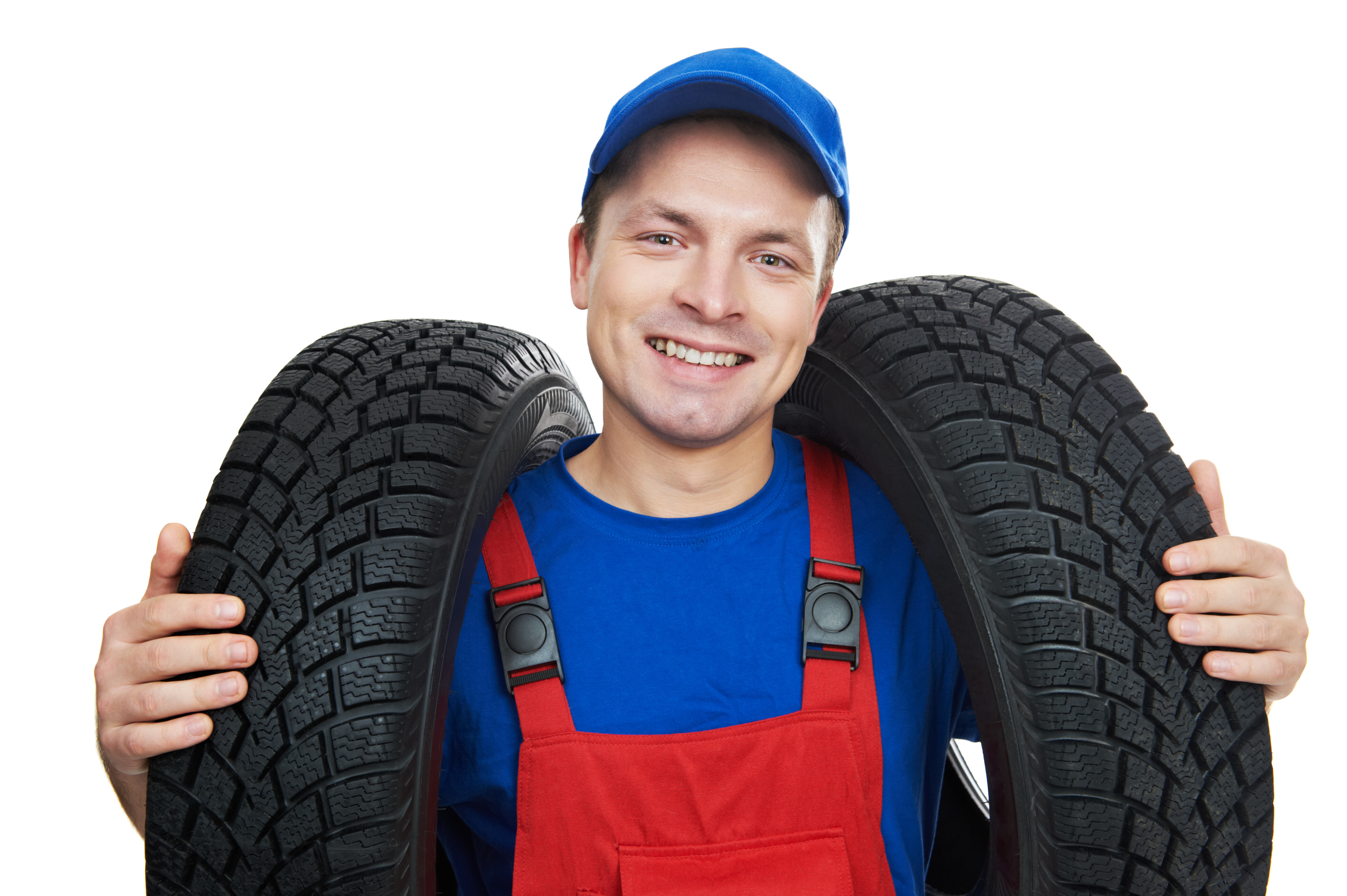 Serviceman repairman automobile mechanic with two car tyres isolated