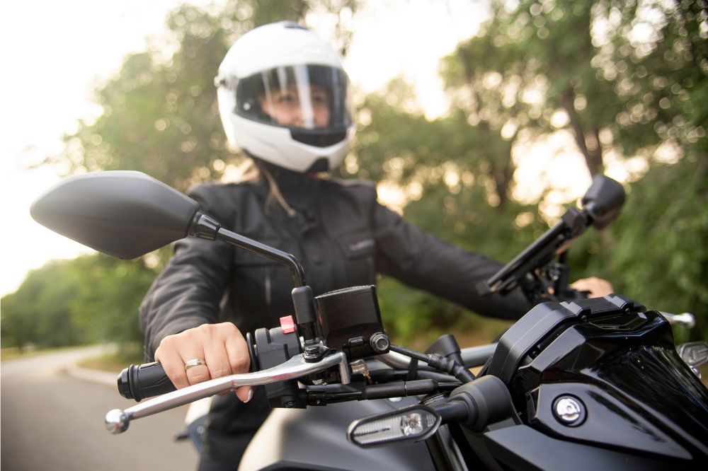 Žena si užíva jazdu na motorke po ceste