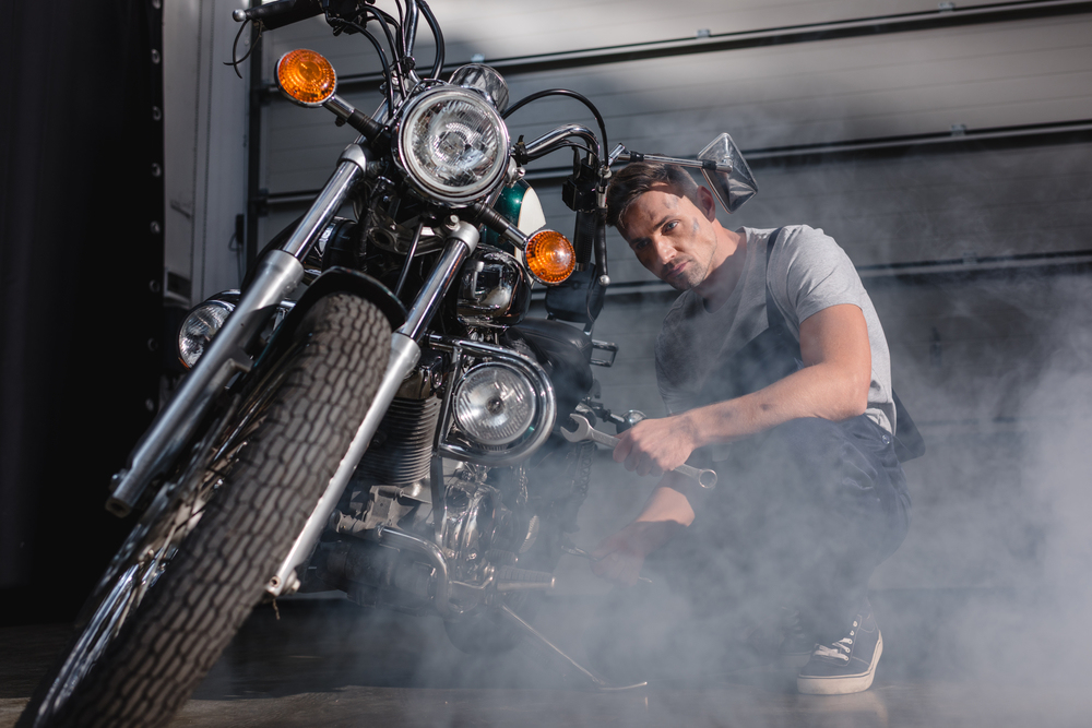 Mechanik opravujúci motorku v garáži
